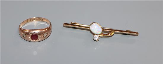 An early 20th century 15ct, white opal and diamond bar brooch and a 9ct gold gypsy set ruby and diamond ring.